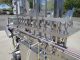 PACKAGING DYNAMICS TWELVE SPOUT STAINLESS AUTOMATIC LIQUID FILLER