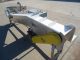 AIR-DRAULIC INCLINED CLEATED BELT CONVEYOR WITH AUTOMATIC DUMP, STAINLESS STEEL