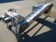 AIR-DRAULIC INCLINED CLEATED BELT CONVEYOR WITH AUTOMATIC DUMP, STAINLESS STEEL