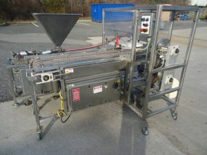 RAQUE SAUCE DEPOSITING SYSTEM FOR FROZEN PIZZA