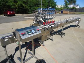 INLINE FILLING SYSTEMS SIX HEAD LEVEL HEAD OVERFLOW PRESSURE FILLER WITH 20 FT. CONVEYOR