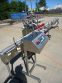 INLINE FILLING SYSTEMS SIX HEAD LEVEL HEAD OVERFLOW PRESSURE FILLER WITH 20 FT. CONVEYOR