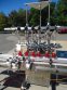 INLINE FILLING SYSTEMS SIX HEAD LEVEL HEAD OVERFLOW PRESSURE FILLER WITH 20 FT. CONVEYOR