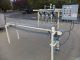 PVC 4 SPOUT STRAIGHT LINE AUTOMATIC PRESSURE GRAVITY LIQUID FILLING MACHINE